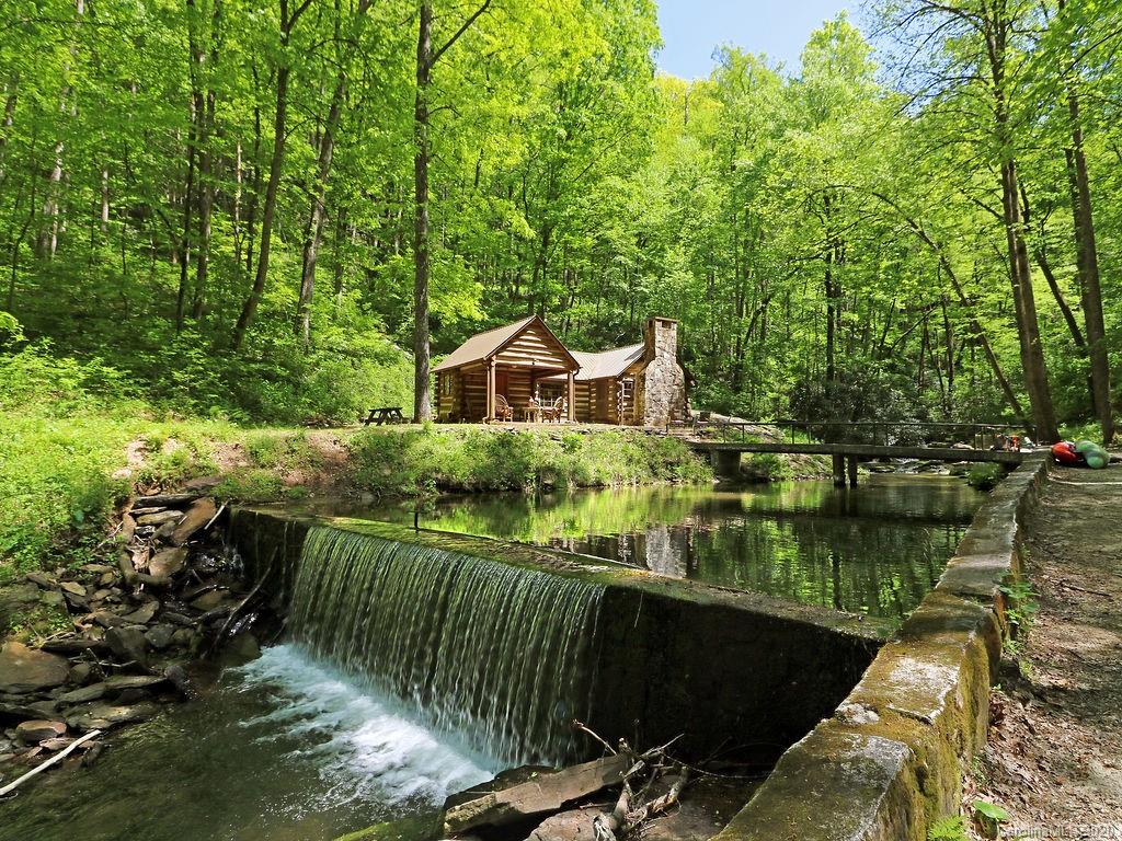 315 Shoals Falls Road Hendersonville, NC 28739 - Photo 19 of 47 a house with river in front of it