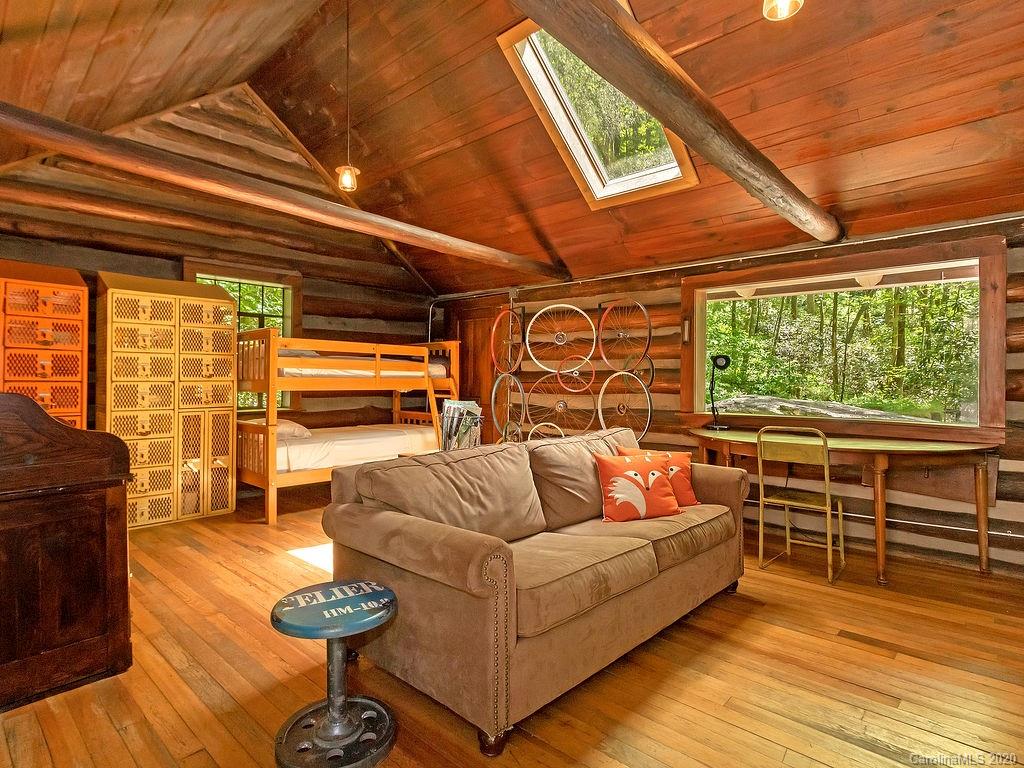 315 Shoals Falls Road Hendersonville, NC 28739 - Photo 22 of 47 a living room with furniture and a large window