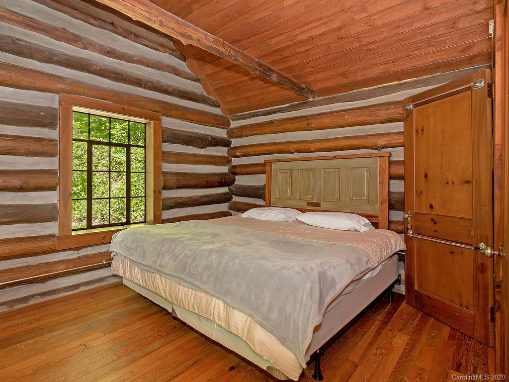 315 Shoals Falls Road Hendersonville, NC 28739 - Photo 23 of 47 a bed sitting in a bedroom next to a window