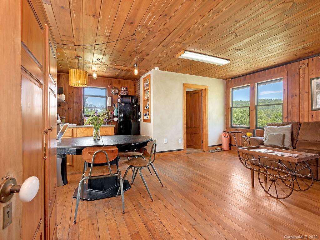 315 Shoals Falls Road Hendersonville, NC 28739 - Photo 30 of 47 a view of a dining room with furniture window and wooden floor