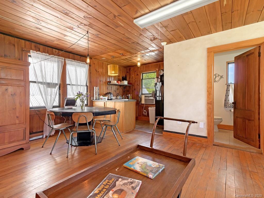 315 Shoals Falls Road Hendersonville, NC 28739 - Photo 31 of 47 a living room with furniture a wooden floor and next to a window