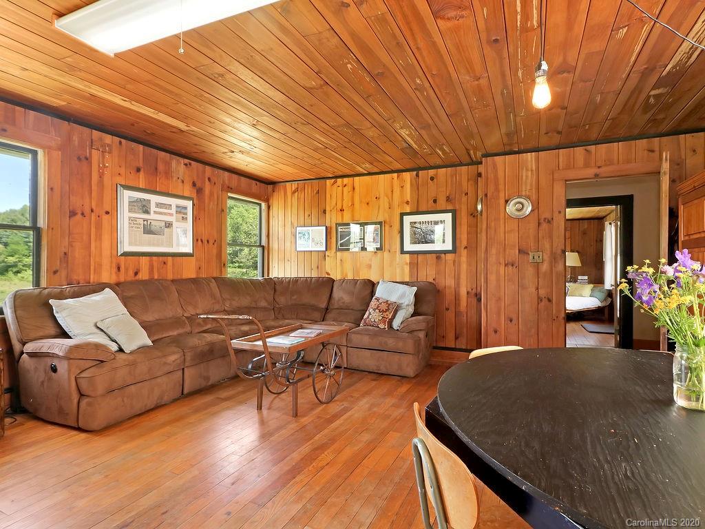 315 Shoals Falls Road Hendersonville, NC 28739 - Photo 32 of 47 a living room with furniture and wooden floor