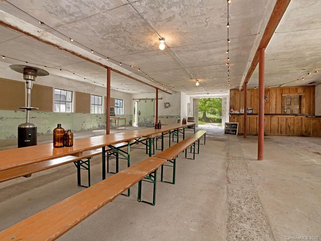 315 Shoals Falls Road Hendersonville, NC 28739 - Photo 35 of 47 a room with lots of wooden furniture and windows