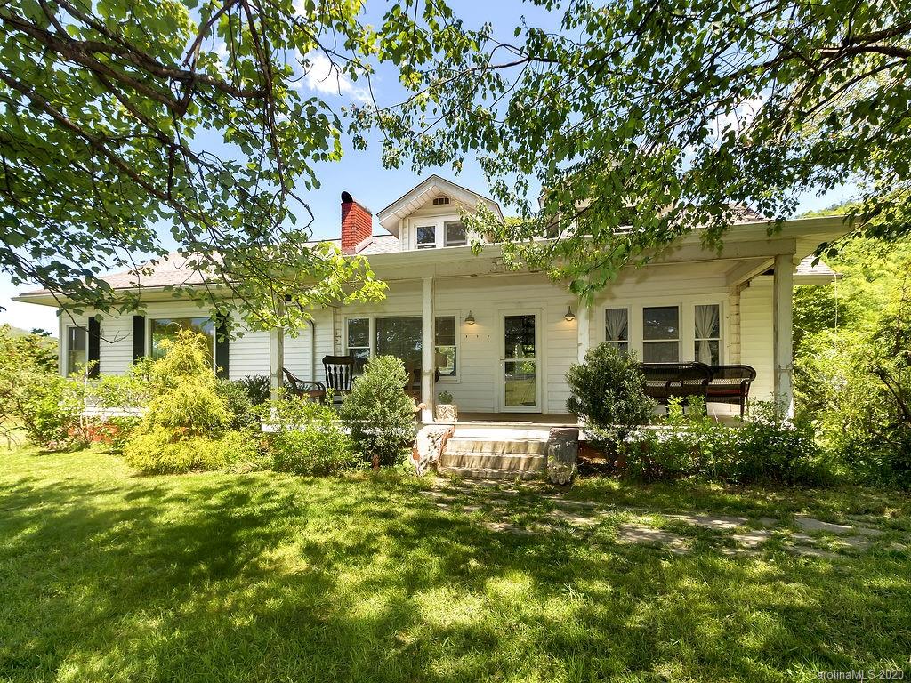 315 Shoals Falls Road Hendersonville, NC 28739 - Photo 5 of 47 a front view of a house with a yard and porch