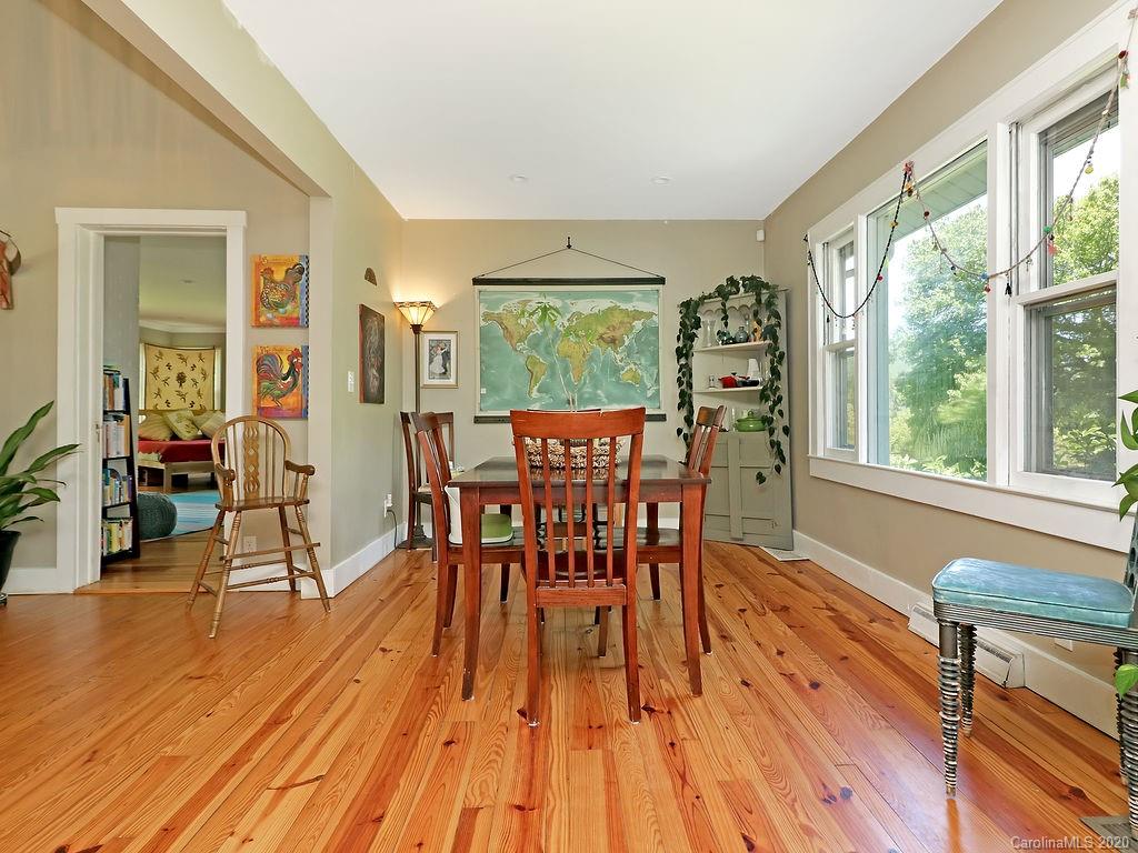 315 Shoals Falls Road Hendersonville, NC 28739 - Photo 9 of 47 a view of a dining room with furniture window and wooden floor