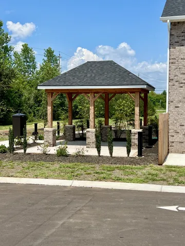 a view of a house with backyard swimming pool and sitting area