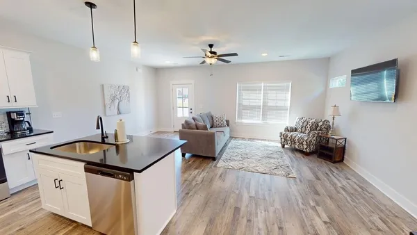 a kitchen with sink cabinets and wooden floor