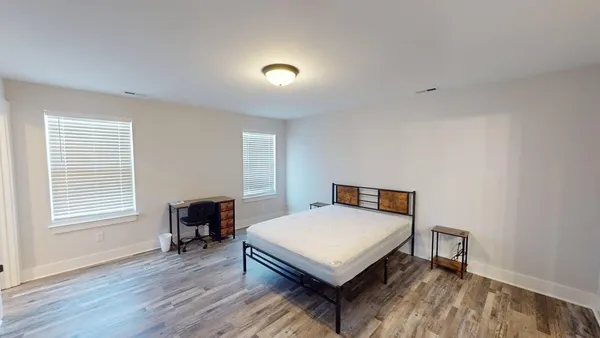 a bedroom with furniture and a window