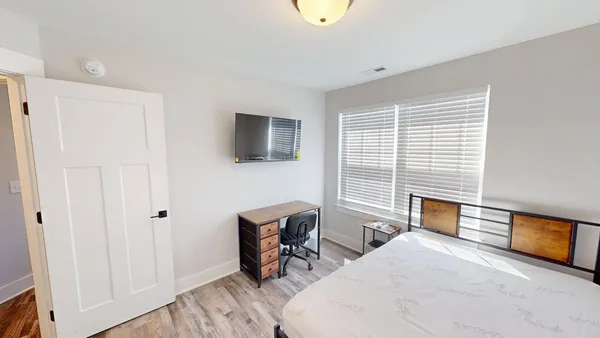 a bedroom with furniture and a window
