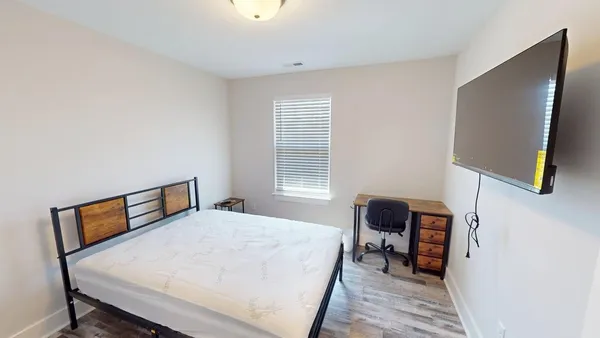 a bedroom with a bed and a chair