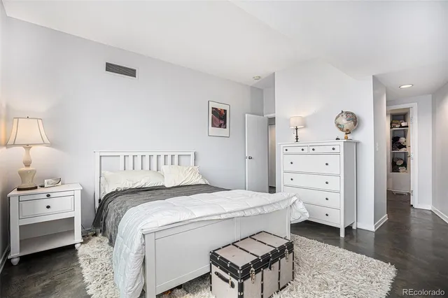 a bedroom with a bed and a window with outer view