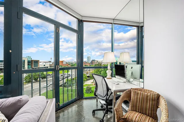 a dining room with furniture water view and a floor to ceiling window