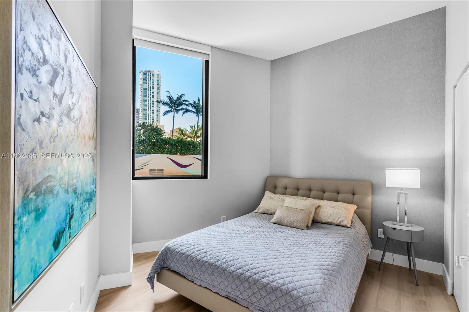 501 Northeast 31st Street, Unit 306 Miami, FL 33137 - Photo 14 of 65 a bedroom with a bed and a painting on the wall
