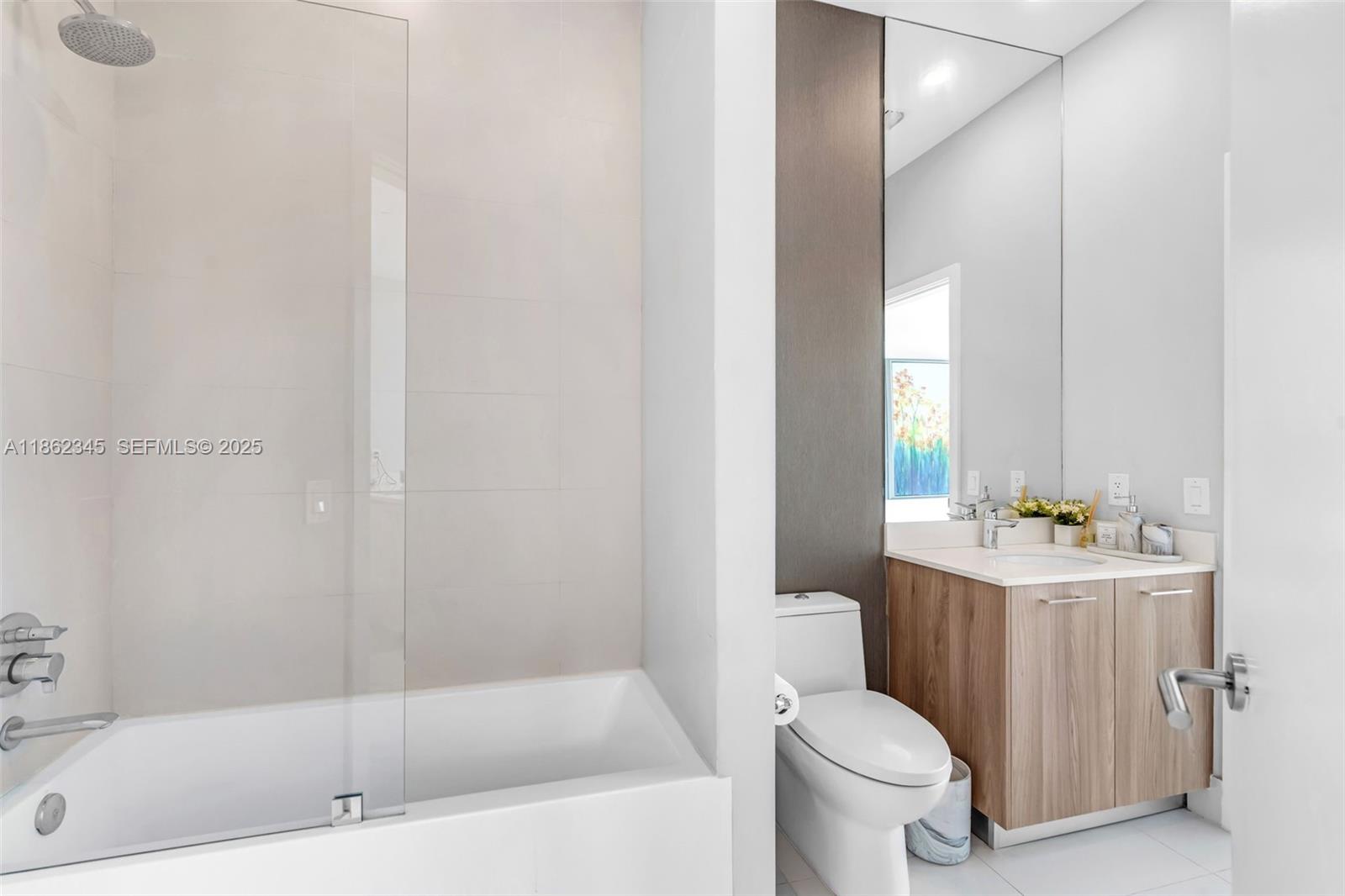 501 Northeast 31st Street, Unit 306 Miami, FL 33137 - Photo 15 of 65 a bath room with a toilet a sink and a bath tub