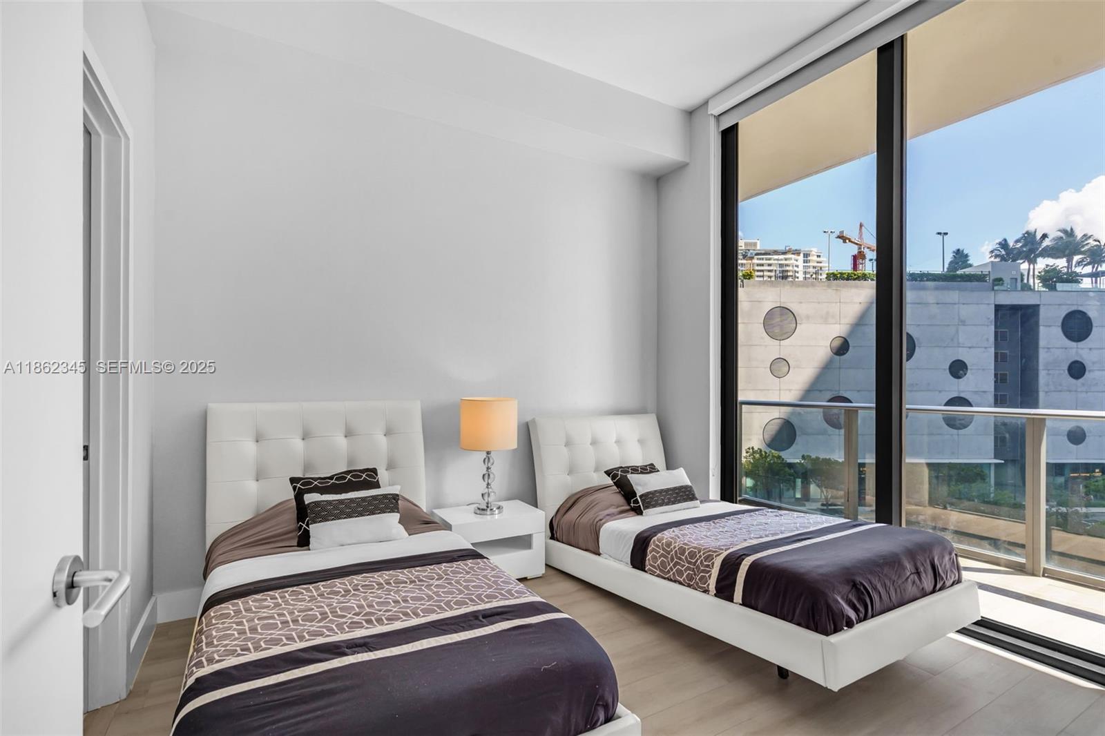 501 Northeast 31st Street, Unit 306 Miami, FL 33137 - Photo 17 of 65 a bedroom with a large bed and a window