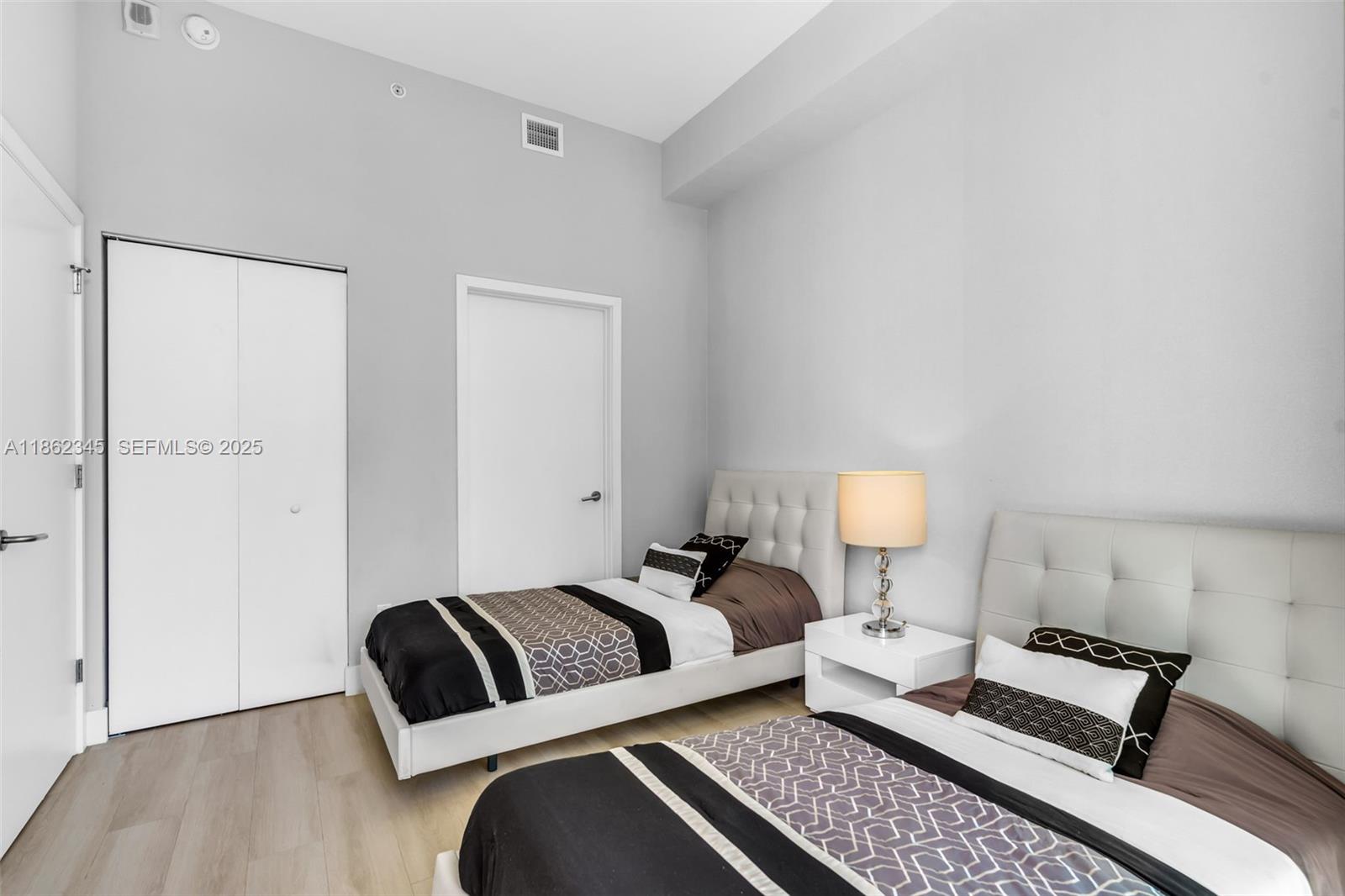 501 Northeast 31st Street, Unit 306 Miami, FL 33137 - Photo 18 of 65 a bedroom with a bed and a couch