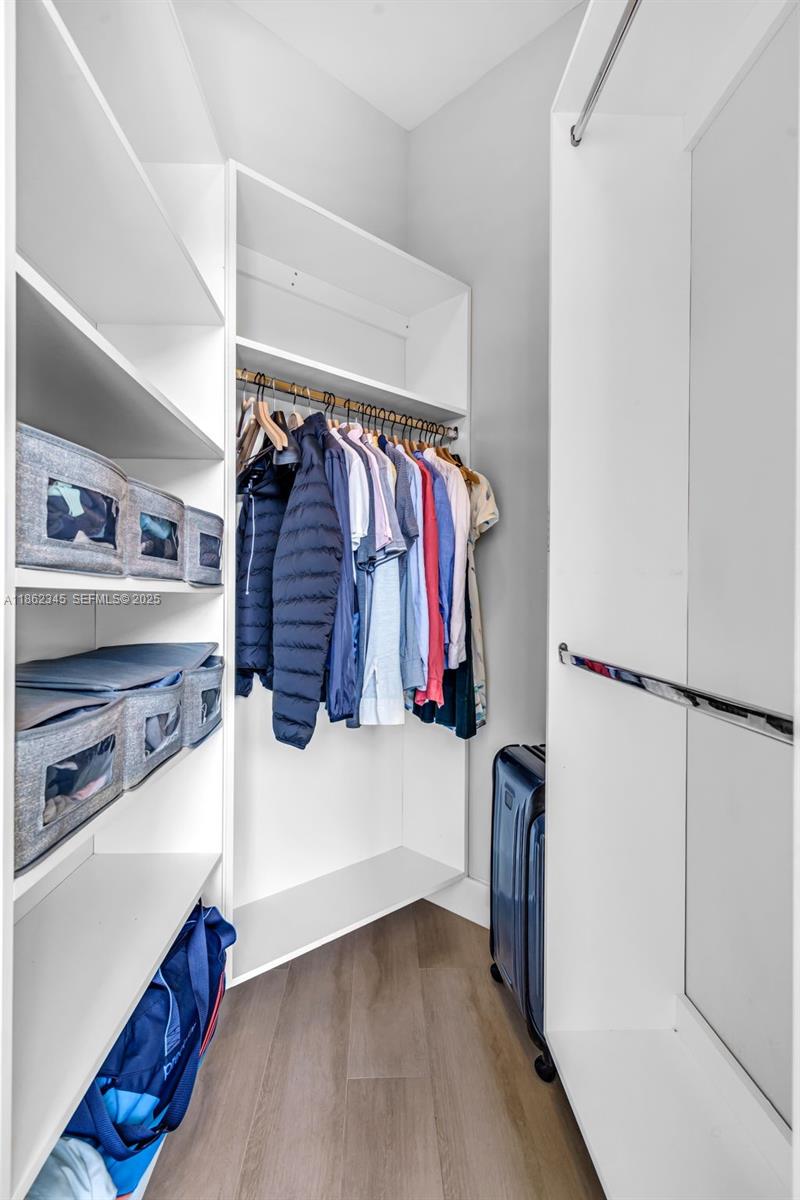 501 Northeast 31st Street, Unit 306 Miami, FL 33137 - Photo 19 of 65 a view of walk in closet with clothes and shoes