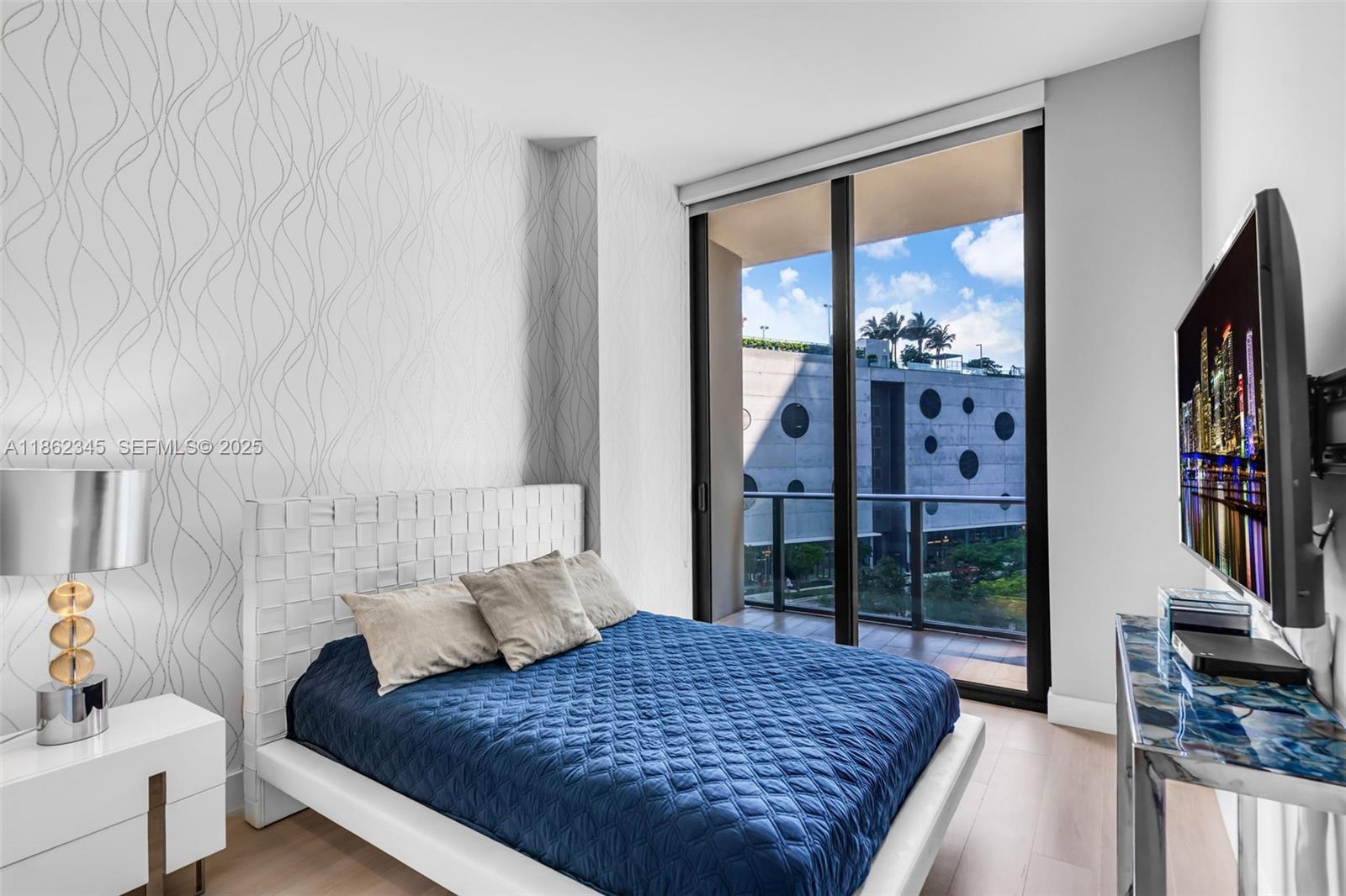 501 Northeast 31st Street, Unit 306 Miami, FL 33137 - Photo 20 of 65 a living room with furniture and a flat screen tv