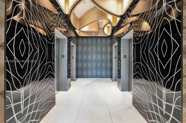 a front view of a building with lots of palm trees