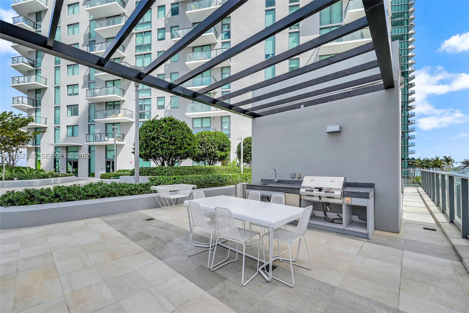 501 Northeast 31st Street, Unit 306 Miami, FL 33137 - Photo 49 of 65 a view of a patio with a backyard