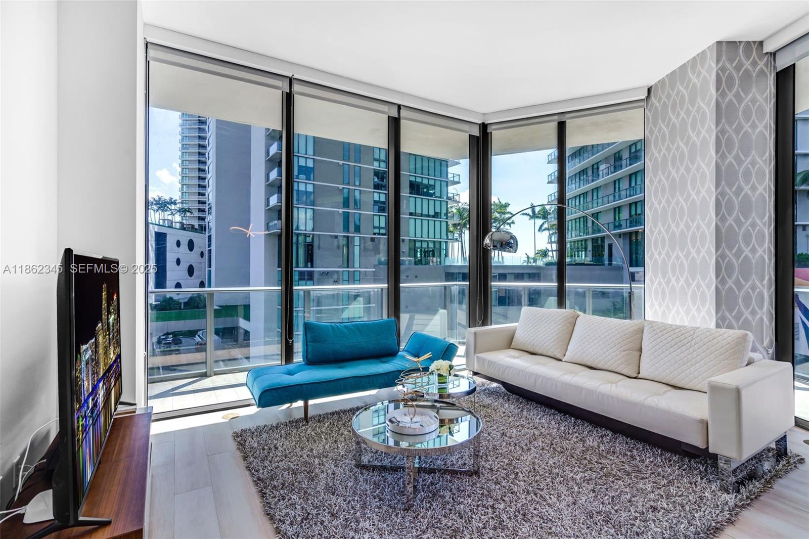 501 Northeast 31st Street, Unit 306 Miami, FL 33137 - Photo 8 of 65 a living room with furniture and a floor to ceiling window