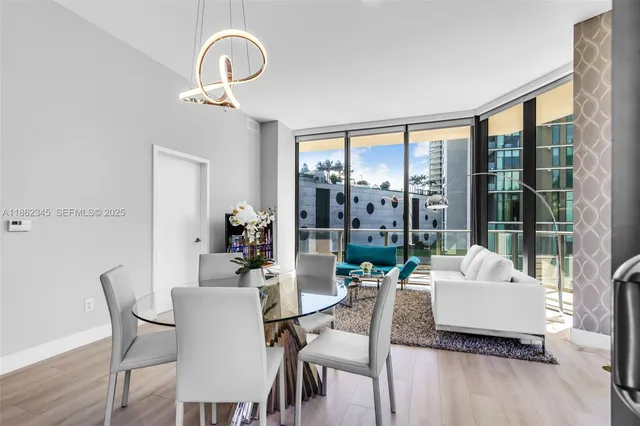 a kitchen with a table chairs stove and cabinets