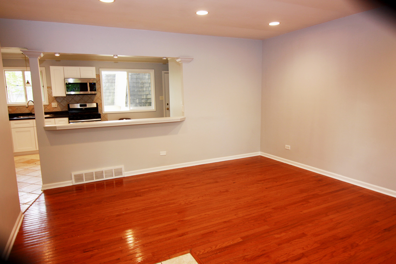 115 Kings Road Carpentersville, IL 60110 - Photo 3 of 16 a view of kitchen with wooden floor and window