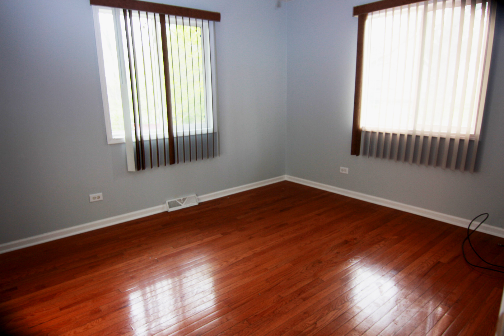115 Kings Road Carpentersville, IL 60110 - Photo 8 of 16 an empty room with wooden floor and windows