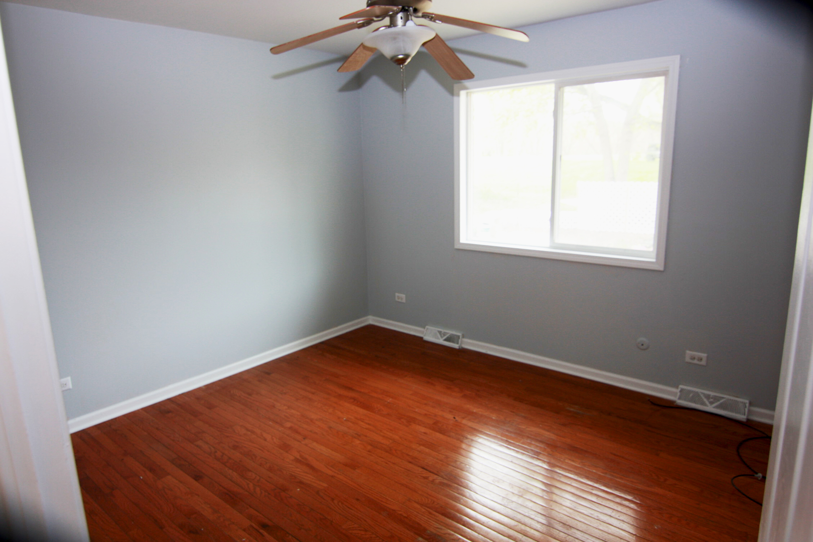 115 Kings Road Carpentersville, IL 60110 - Photo 9 of 16 wooden floor in an empty room with a window