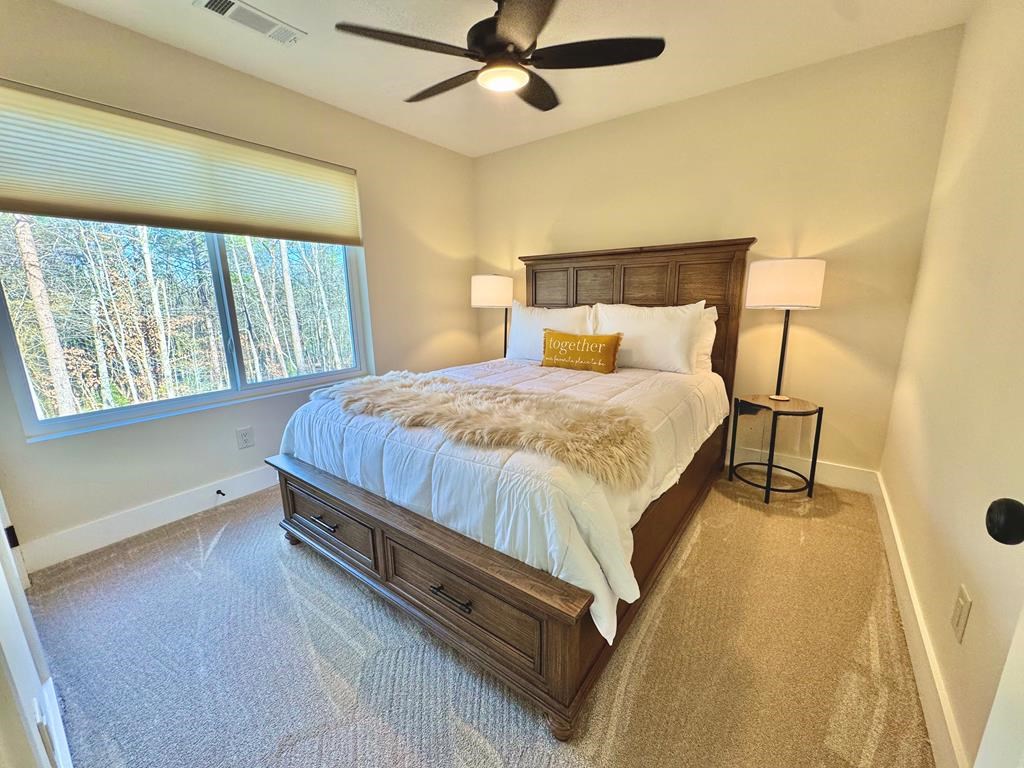 939 Sunset Road Epworth, GA 30541 - Photo 15 of 30 a bed sitting in a bedroom next to a window