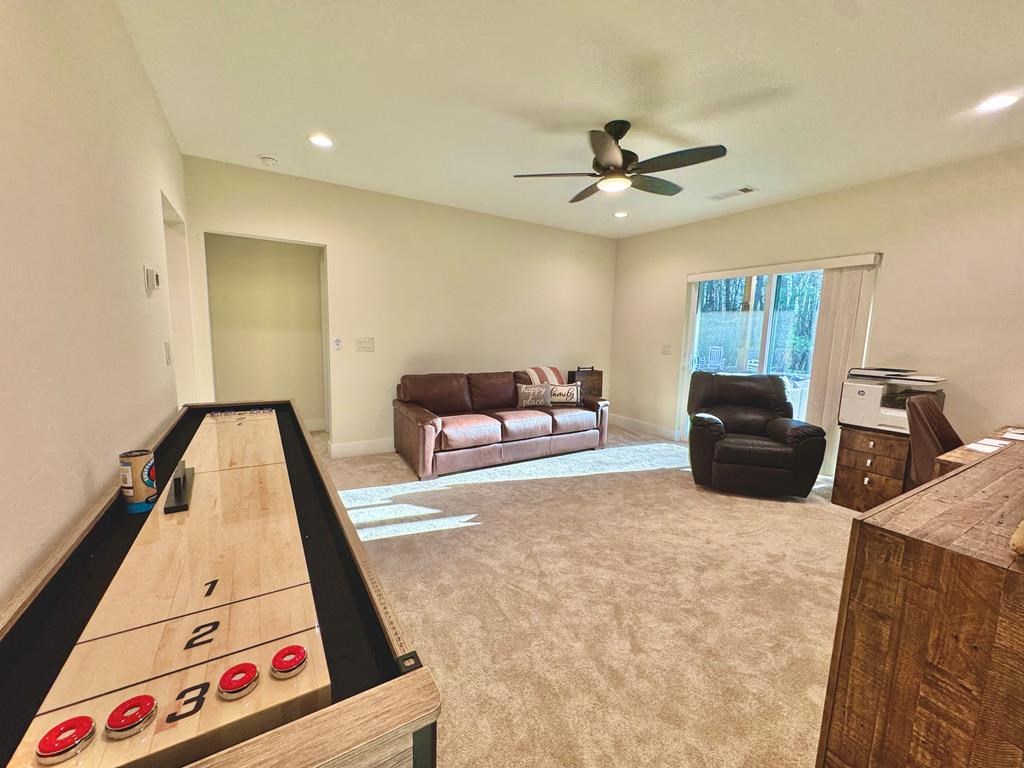 939 Sunset Road Epworth, GA 30541 - Photo 19 of 30 a living room with furniture and a flat screen tv