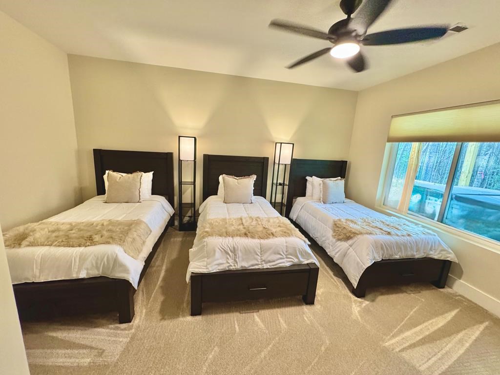 939 Sunset Road Epworth, GA 30541 - Photo 23 of 30 a bedroom with two beds and a large window