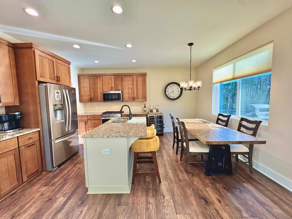 939 Sunset Road Epworth, GA 30541 - Photo 5 of 30 a living room with stainless steel appliances granite countertop furniture wooden floor and a kitchen view