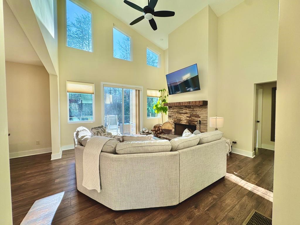 939 Sunset Road Epworth, GA 30541 - Photo 10 of 30 a living room with furniture a fireplace and a flat screen tv