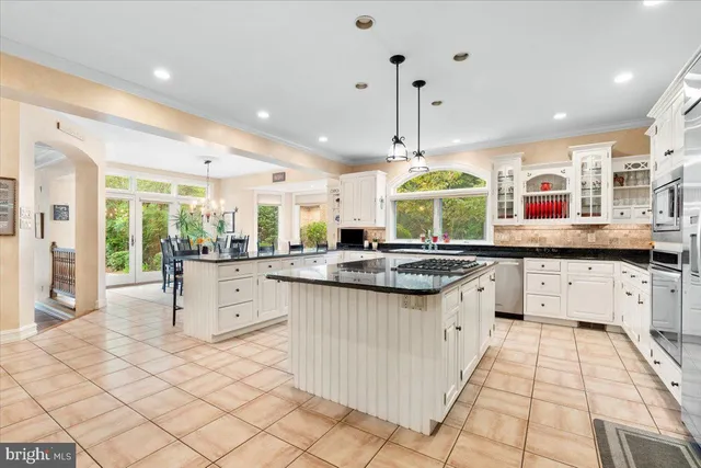 a kitchen with stainless steel appliances and cabinets