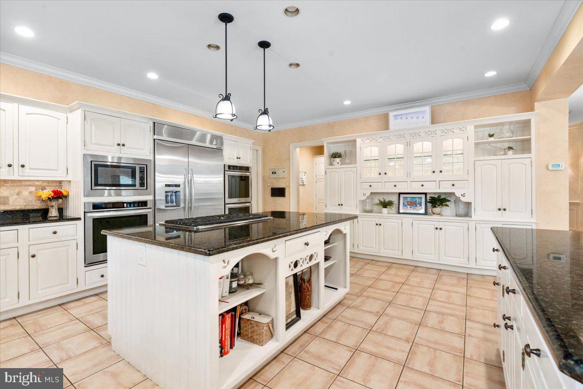 5948 White Flint Drive Frederick, MD 21702 - Photo 15 of 94 a large kitchen with stainless steel appliances granite countertop a stove and white cabinets