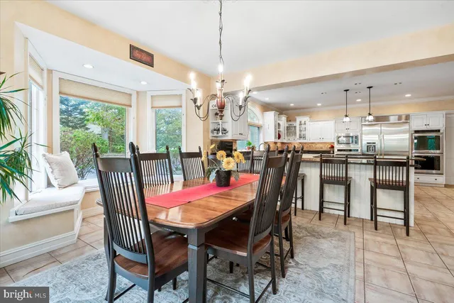 a dining room with furniture a rug and a chandelier