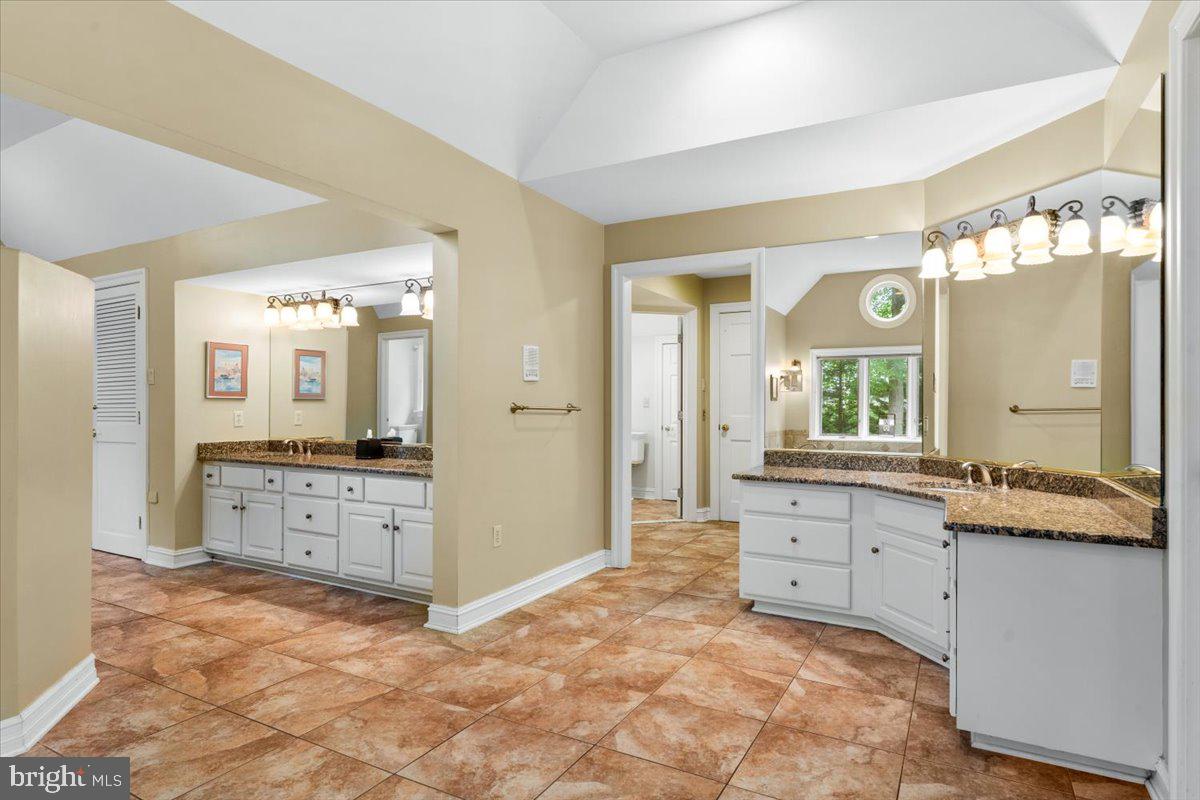 5948 White Flint Drive Frederick, MD 21702 - Photo 44 of 94 a large bathroom with a granite countertop sink mirror and a