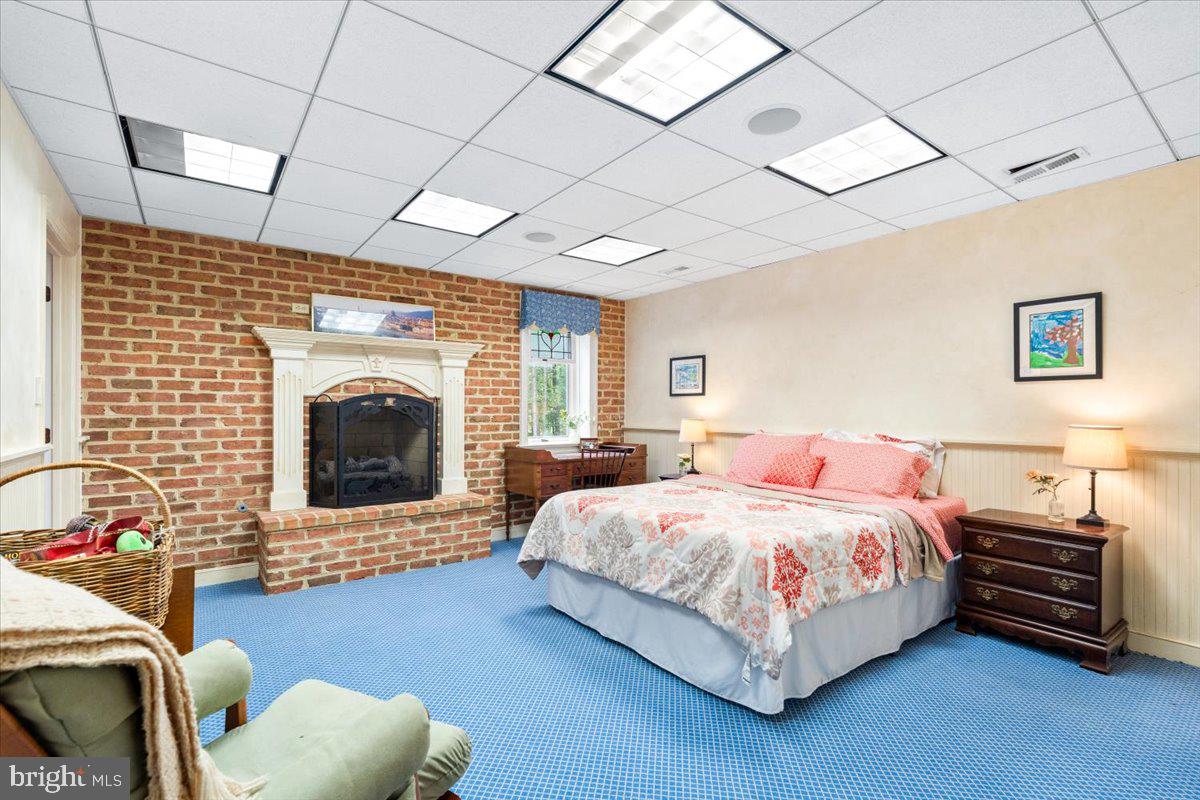 5948 White Flint Drive Frederick, MD 21702 - Photo 56 of 94 a bedroom with a bed and a fireplace