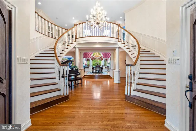 a view of staircase with wooden floor and a rug