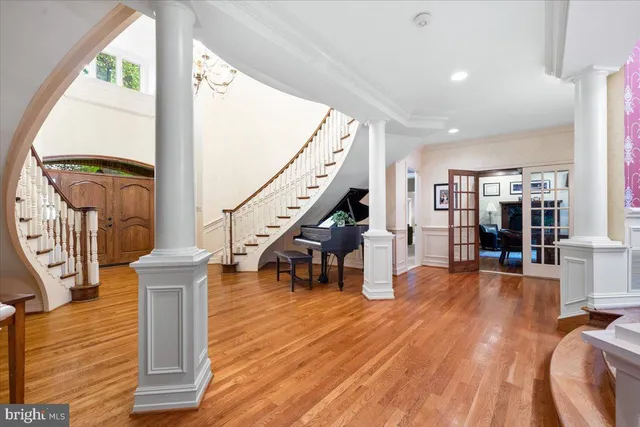 a kitchen with stainless steel appliances granite countertop a stove a sink a refrigerator and white cabinets