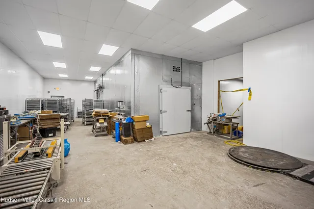 a living room with furniture and gym equipment