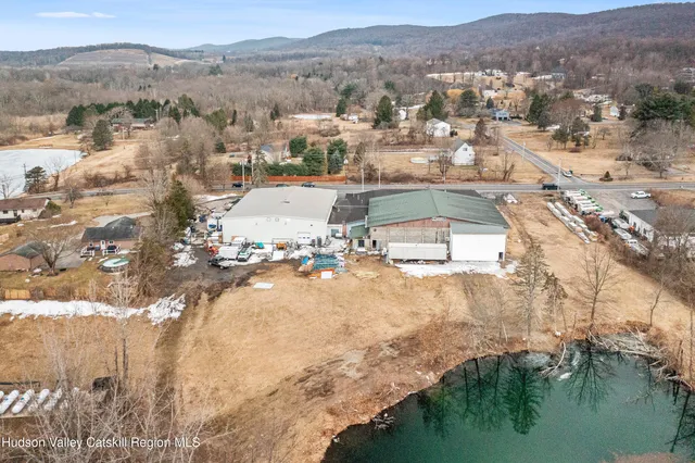 an aerial view of residential houses with outdoor space and river