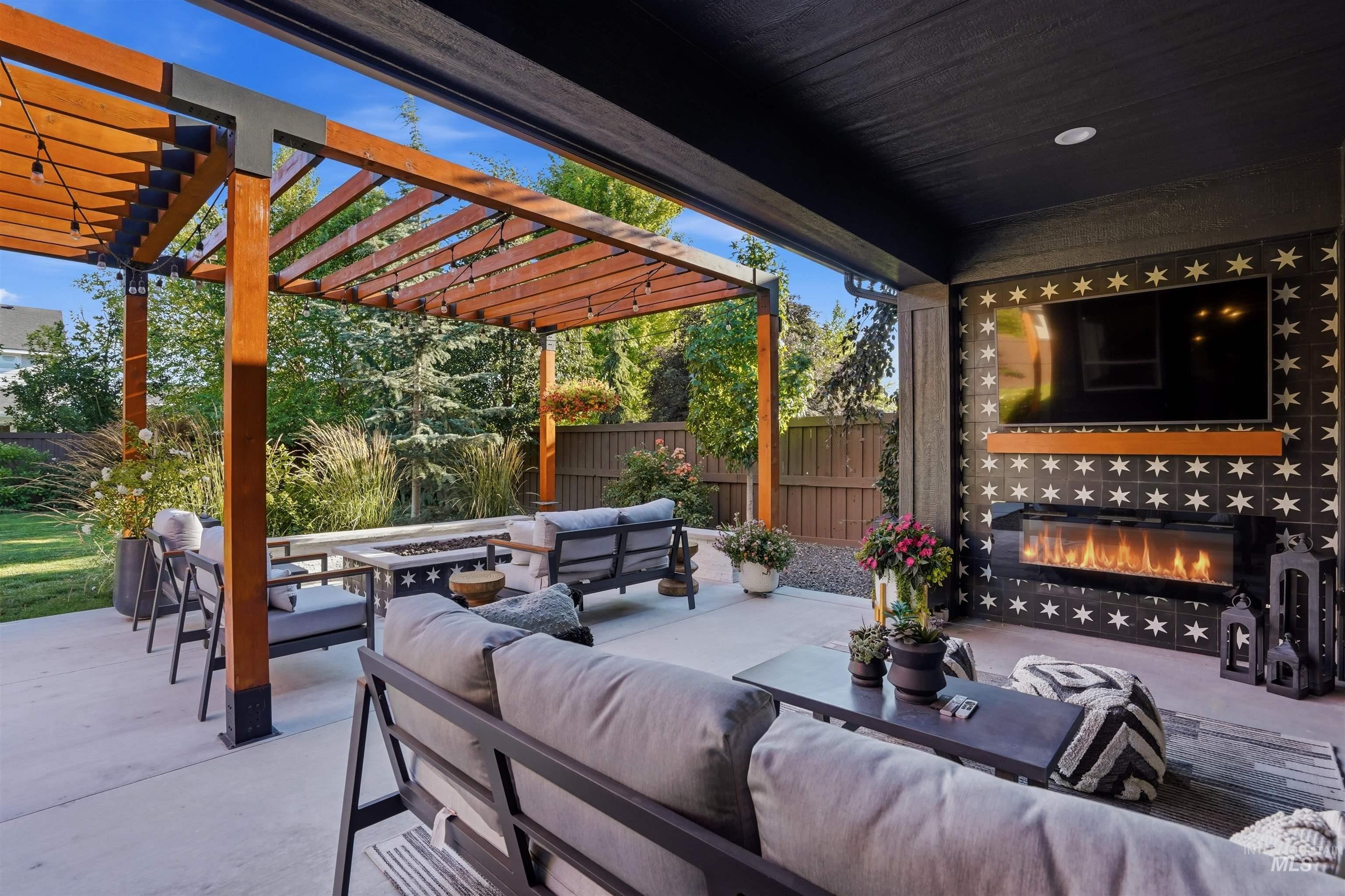 4323 West Ladle Rpds Drive Meridian, ID 83646 - Photo 44 of 49 Covered patio featuring an outdoor fireplace with decorative tile surround and an integrated television