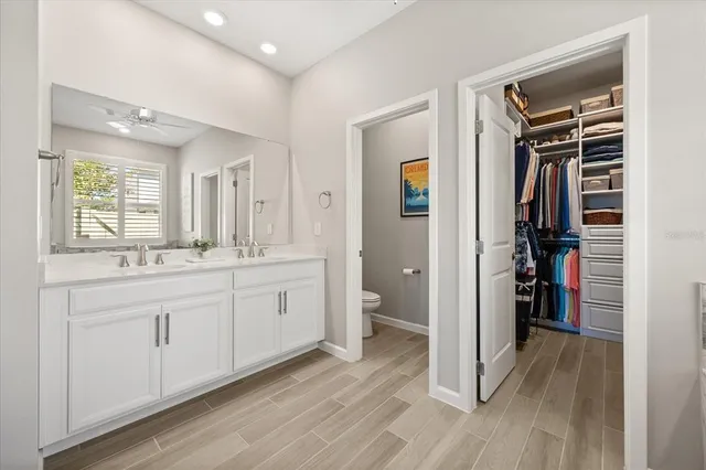 a spacious bathroom with a double vanity sink and a mirror