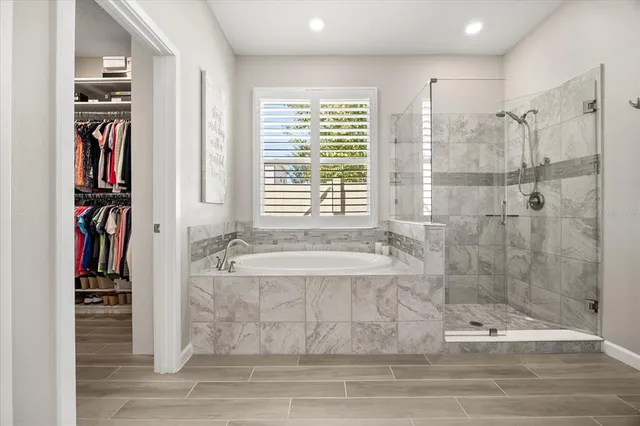 a bathroom with a bathtub and a shower