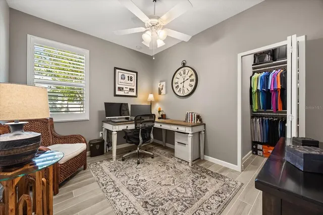 a living room with furniture a window and a flat screen tv