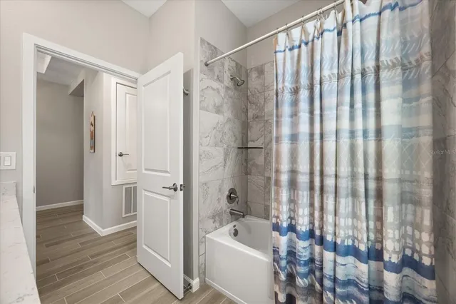 a bathroom with a shower curtain and a sink