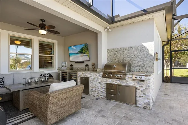 a living room with furniture a fireplace and a large window