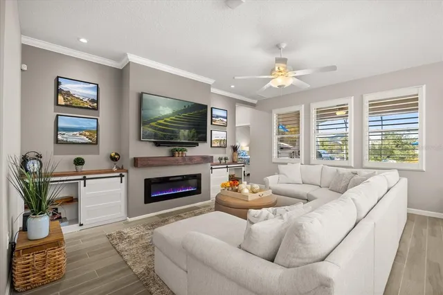 a living room with furniture a flat screen tv and a fireplace